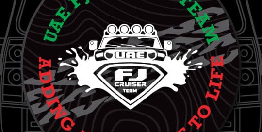 UAE FJ Cruiser Team custom tire cover with adventure theme and logo.