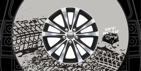 Jeep off-road custom tire cover with tire and Jeep logo on vehicle trunk.