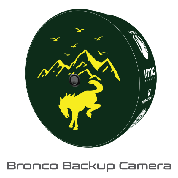 Ford Bronco rear tire fitted with a dark green custom tire cover featuring a yellow Mustang and mountain design with backup camera opening